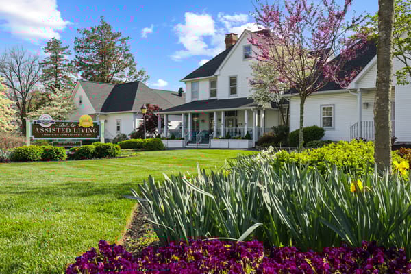 Exterior view of an assisted living facility with landscaped gardens