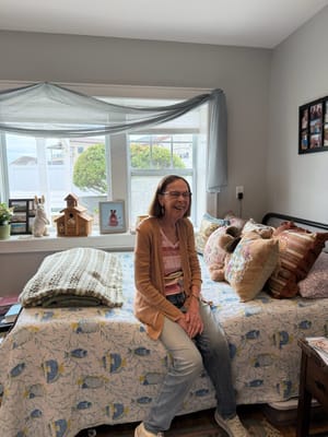 Resident smiling in a cozy private room