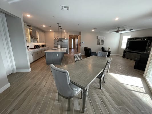 Bright common area with modern furniture and kitchen