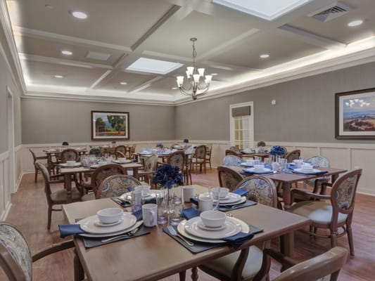 Elegant dining room set with dishes and floral centerpieces