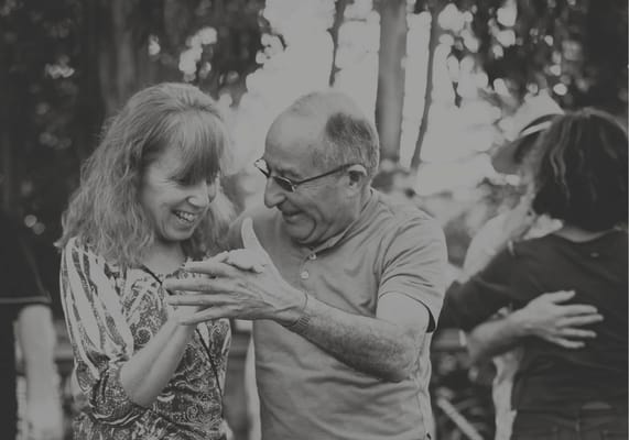 Two seniors dancing joyfully outdoors