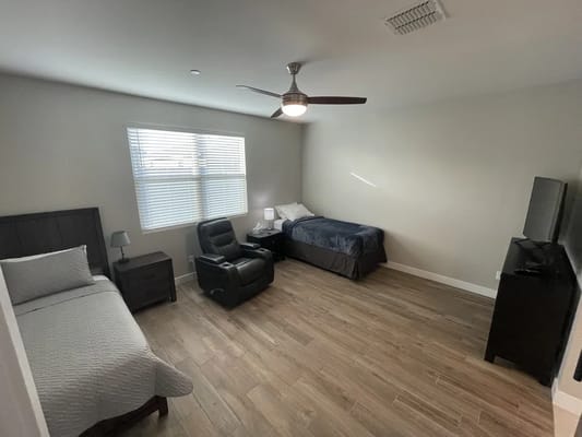 Private resident room with bed and comfortable seating