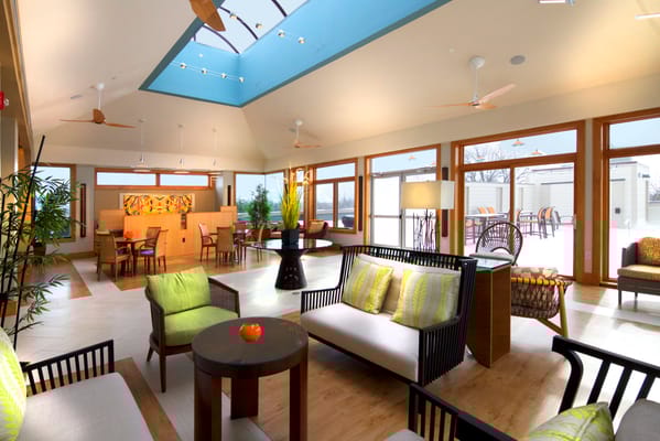 Bright common area with seating and large windows