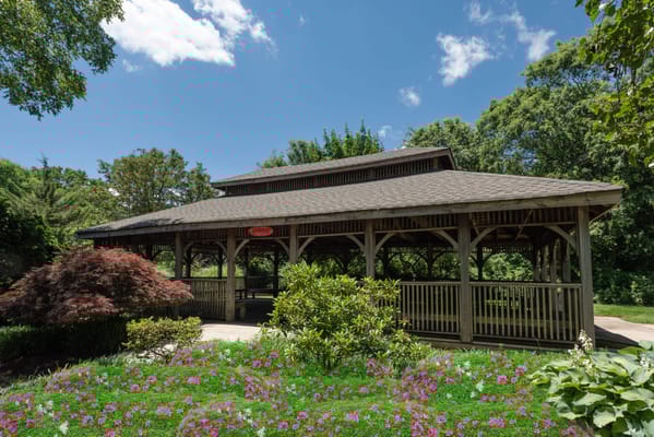 Exterior view of a gazebo surrounded by flowers