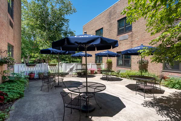 Outdoor patio area with tables and umbrellas