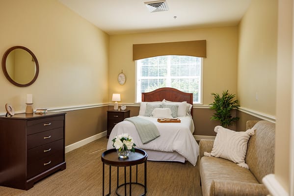 Cozy bedroom with a bed, couch, and decor