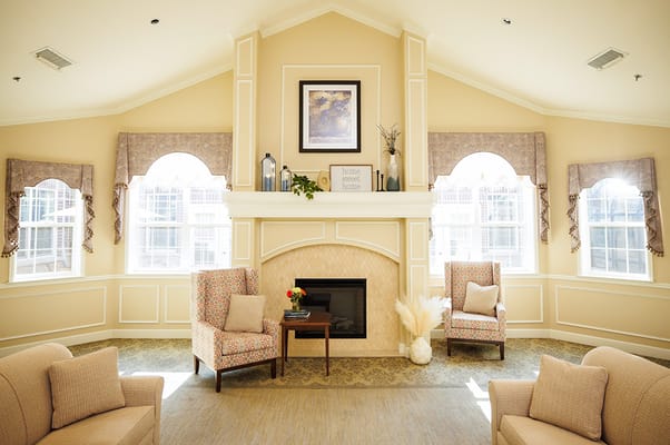 Bright common area with cozy seating and fireplace