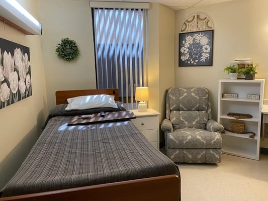 Cozy resident room with a bed and armchair