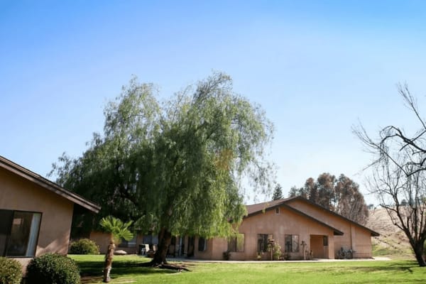 Exterior view of a senior living facility with trees
