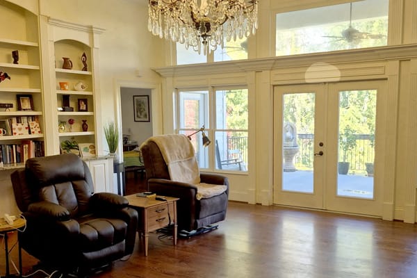 Bright common area with seating and large windows