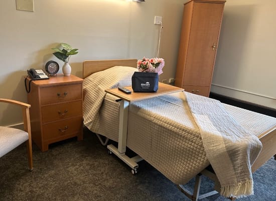 A cozy private resident room with a bed and furniture