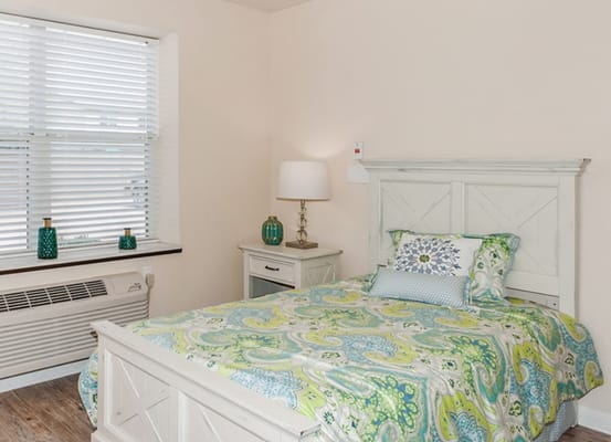 Cozy bedroom with colorful bedding and natural light