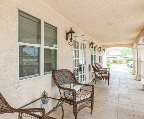 Covered patio with seating area and decor