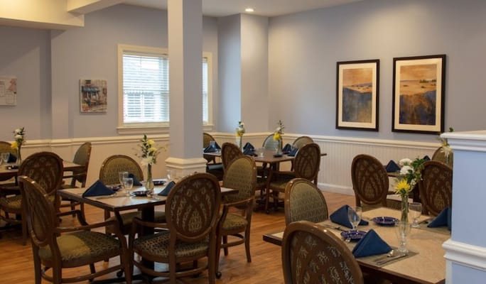 Seating area in the dining room with tables set for a meal