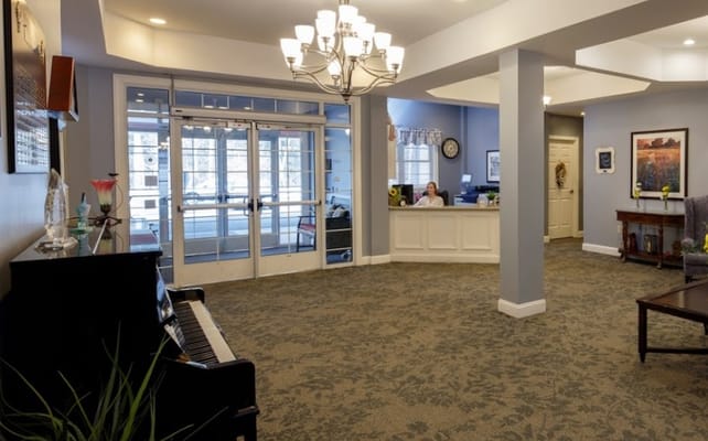 View of the lobby with piano and reception area.