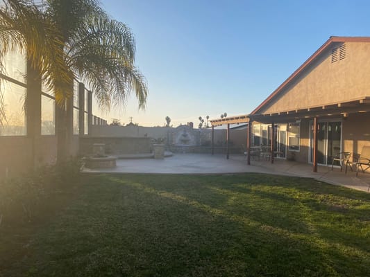 Outdoor area of Adriana Elderly Care Homes with patio and grass