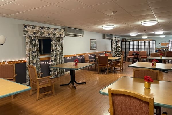 Interior of a cozy dining area with tables and decorations