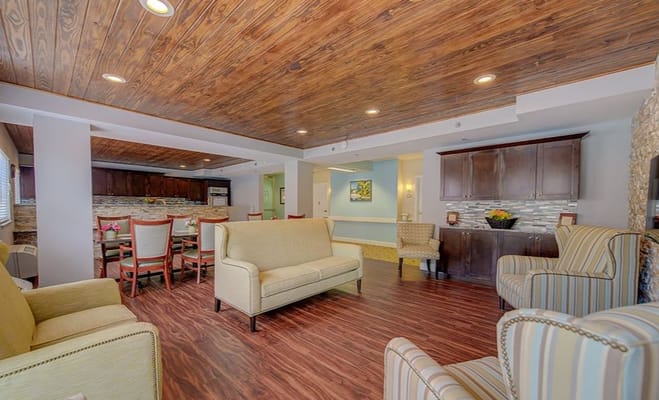 Bright common area with comfortable seating and wooden ceiling