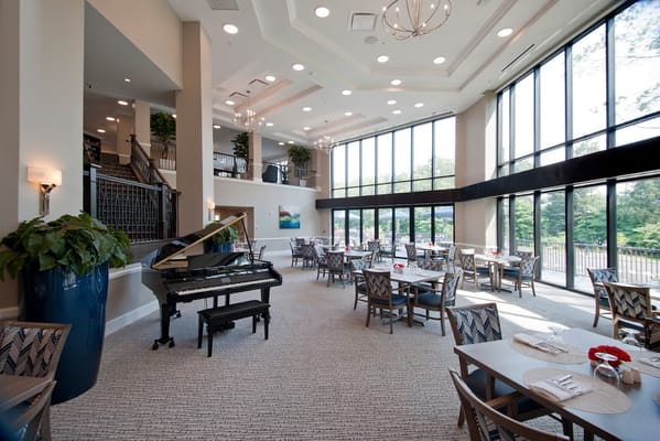 Bright dining area with large windows and piano