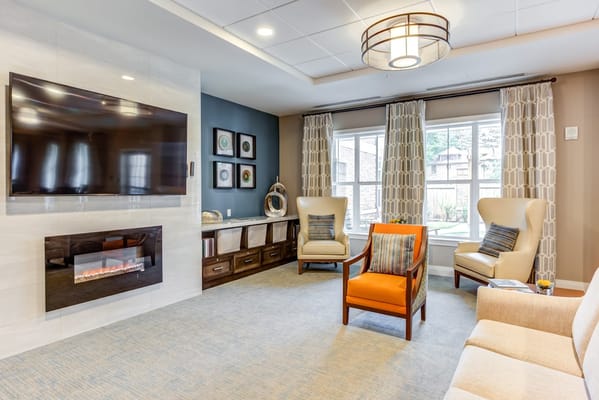 Bright common area with seating and fireplace