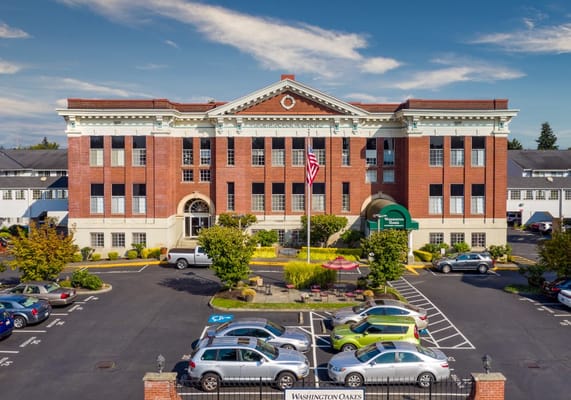 Exterior view of Washington Oakes facility with parking and gardens