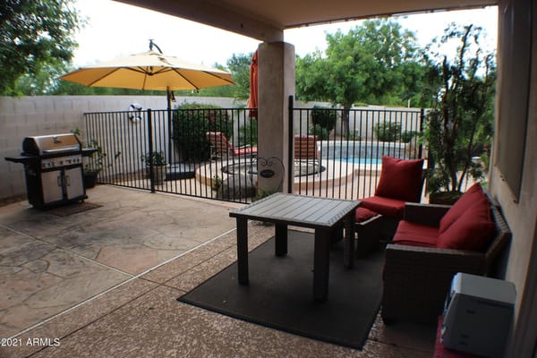 Patio area with seating and grill
