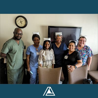Staff members posing together in a common area