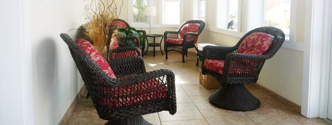 Cozy seating area with wicker chairs and floral cushions