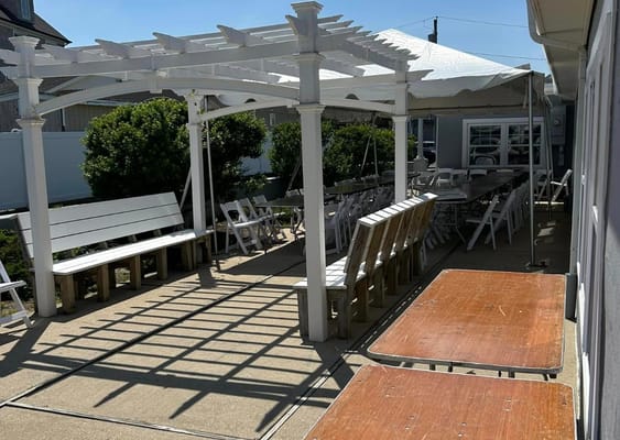 Outdoor shaded dining area with chairs and tables