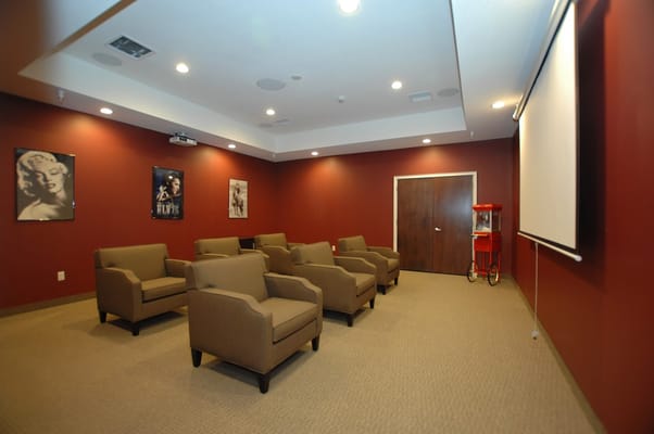 A cozy common area with seating and movie posters