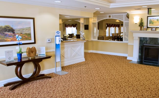 Bright lobby area with seating and a reception desk