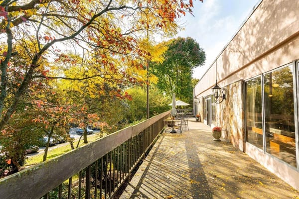 Outdoor area with autumn leaves and seating