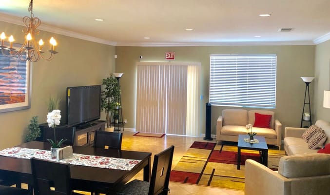 Spacious common area with dining table and seating