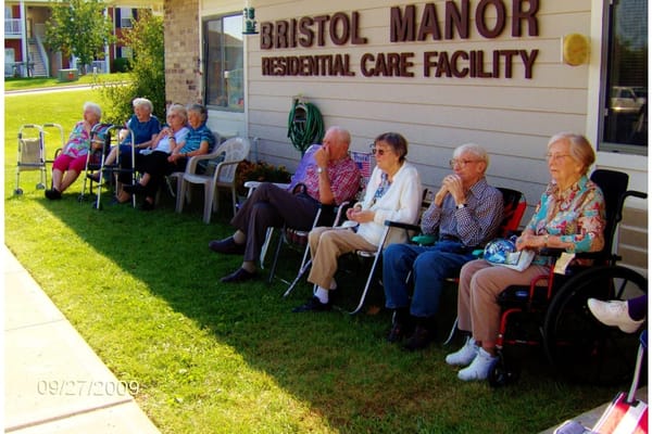 Residents enjoying time outdoors at Bristol Manor