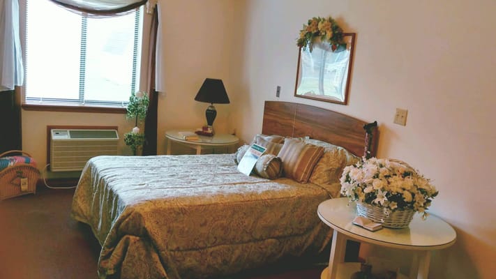 A cozy resident room with a bed and decor