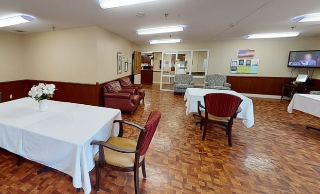 Common area with tables and seating for residents
