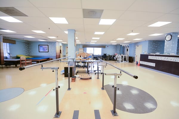 Rehabilitation gym with exercise equipment and bars