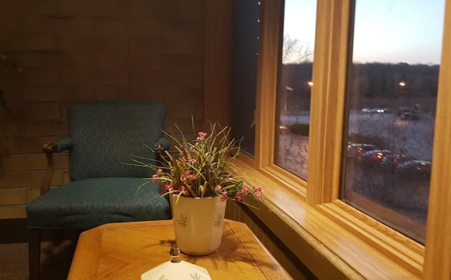 Cozy seating area with flower arrangement by the window