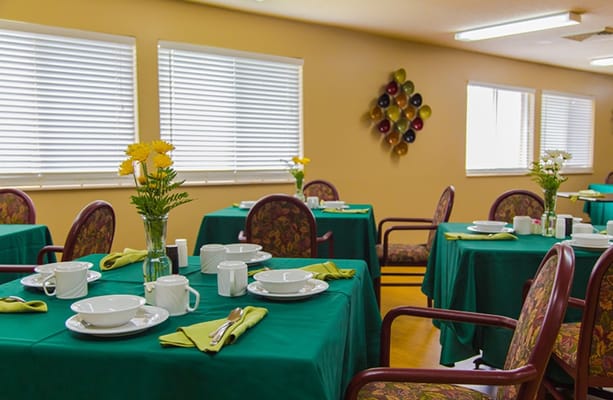 Bright dining room with tables set for a meal