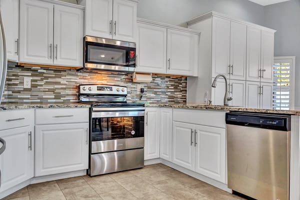 Bright and modern kitchen with stainless steel appliances and granite countertops