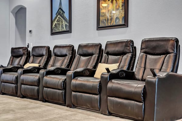 Row of black recliners in a seating area