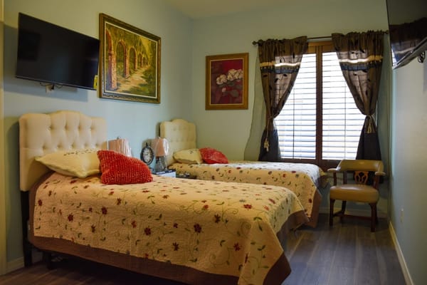 Cozy resident room with twin beds and natural light