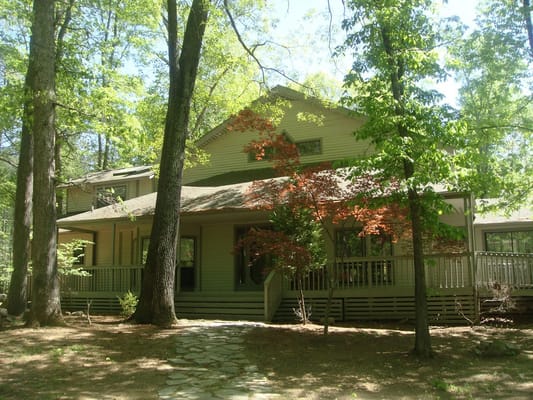 Exterior view of a care home surrounded by trees