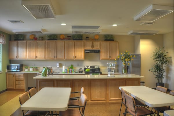 Bright kitchen area with dining tables and cabinets