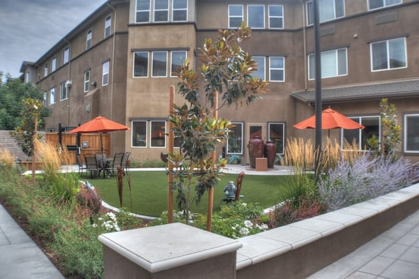 A landscaped outdoor space with seating and umbrellas