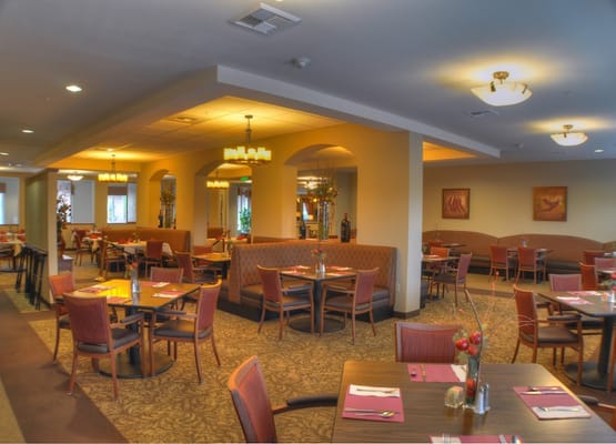Bright dining room with tables set for meals