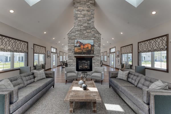 Bright and spacious common area with couches and fireplace