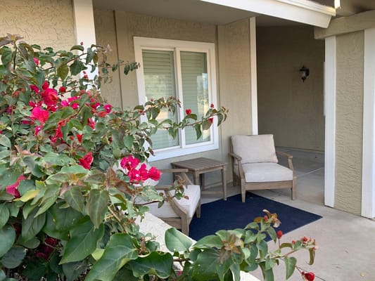 Outdoor seating area with flowers and plants