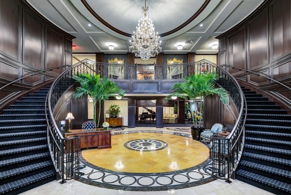 Elegant lobby with grand staircase and chandelier