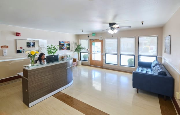 Reception desk at Courtyard Healthcare Center with a staff member working.